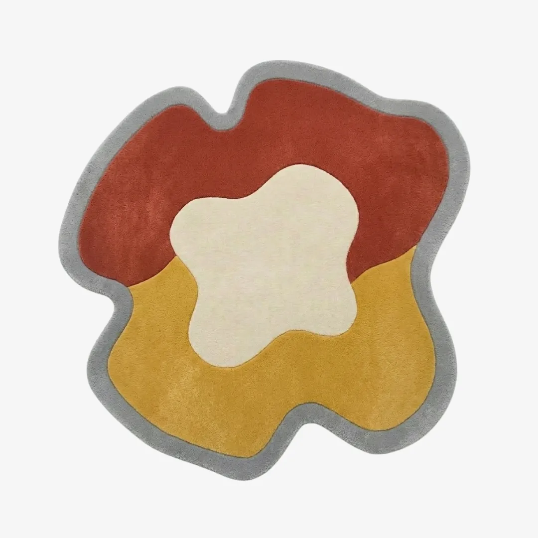 mesa flow rug top view Mesa Flow organic irregular-shaped tufted area rug featuring abstract color blocks in rust red, mustard yellow, and cream with a grey border, displayed flat.