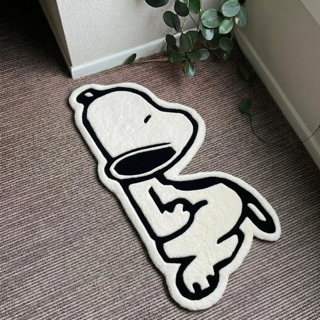Nuvello Pup handmade tufted area rug featuring a black and white cartoon dog silhouette design, displayed flat on a carpeted floor.