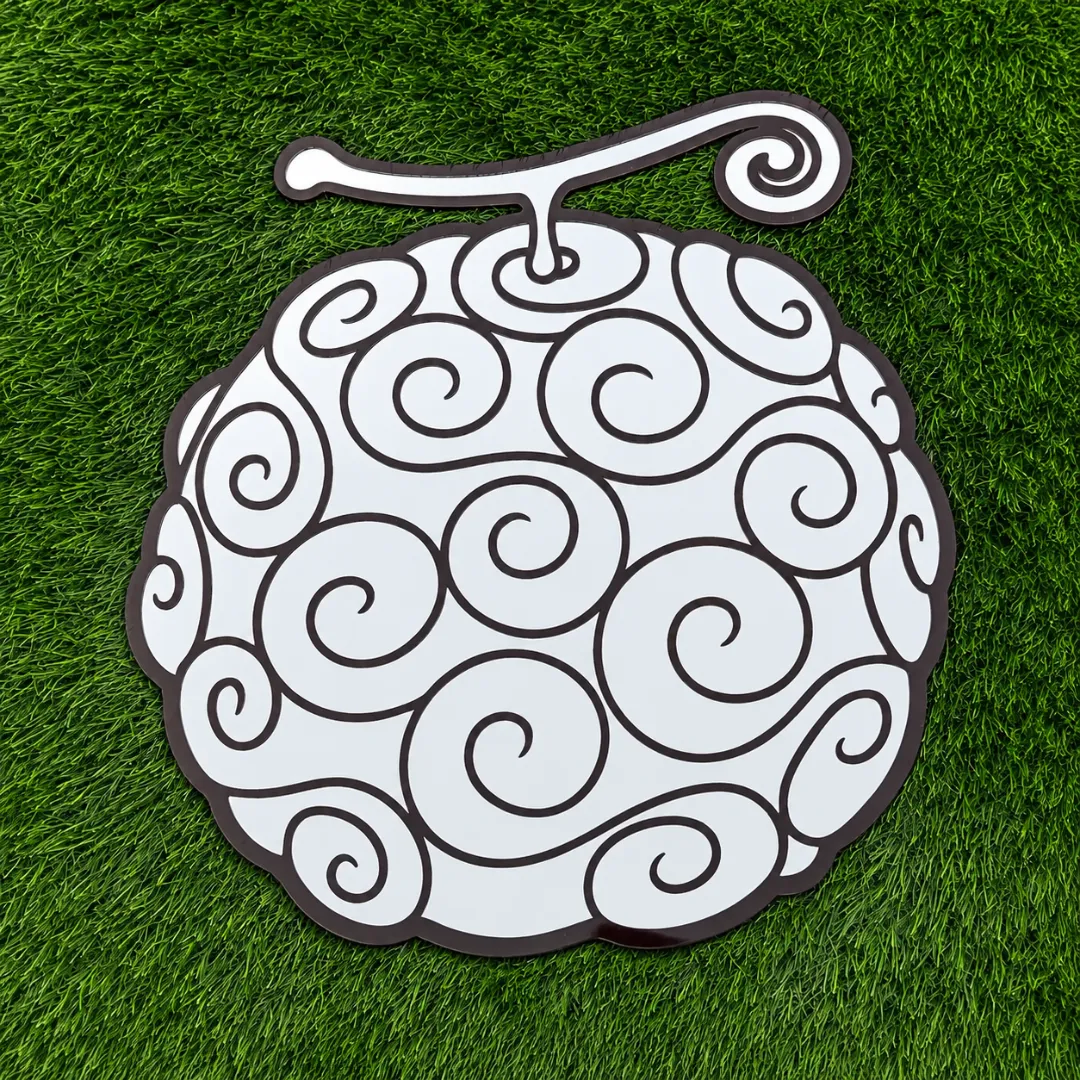 Nuvira Cloud novelty spiral-patterned fruit-shaped wall mirror with black graphic outlines, mounted on a plain white wall.