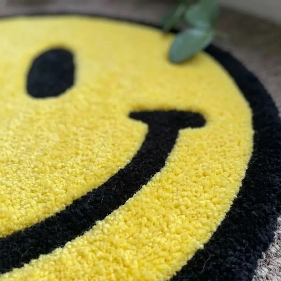 solvani smile rug close up texture Close-up of the plush tufted pile texture, carved borders, and black yarn details on the Solvani Smile designer rug.