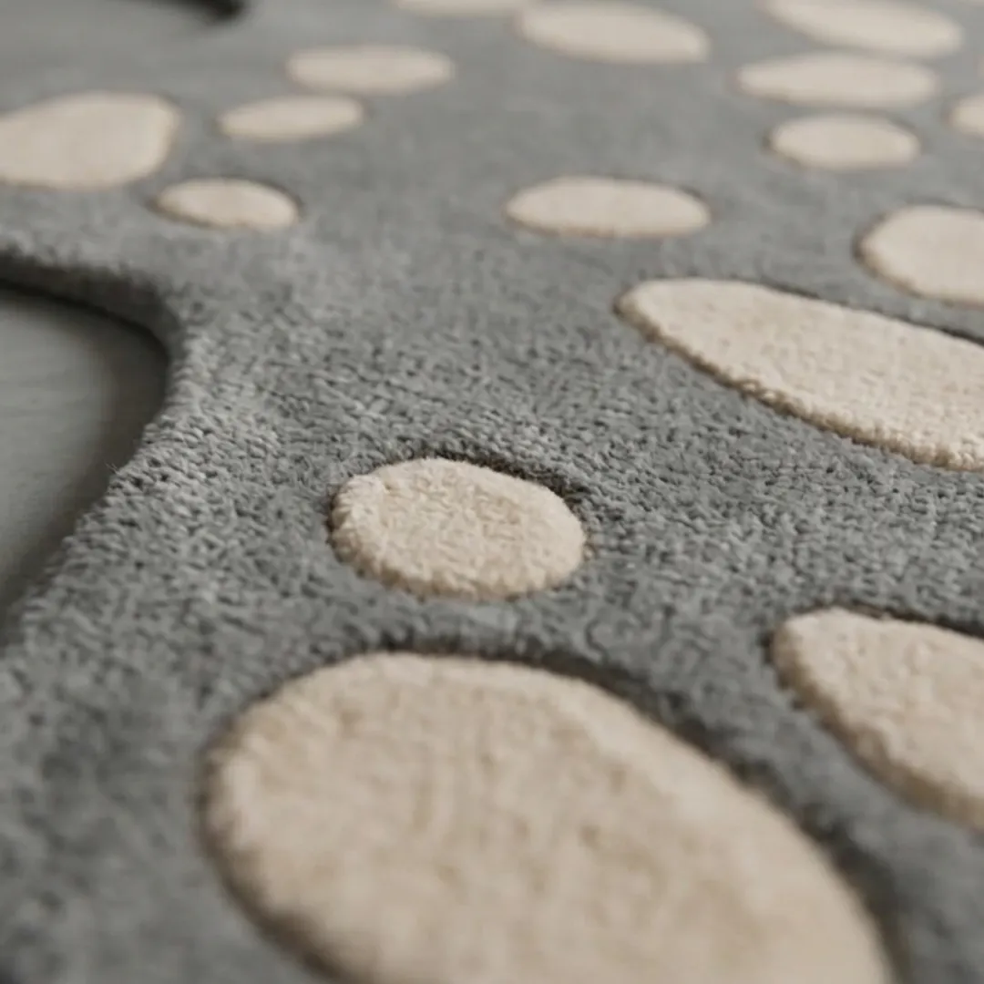 stone mosaic rug close up texture Close-up of the plush tufted pile texture, carved stone details, and contrasting grey and cream tones on the Stone Mosaic rug.