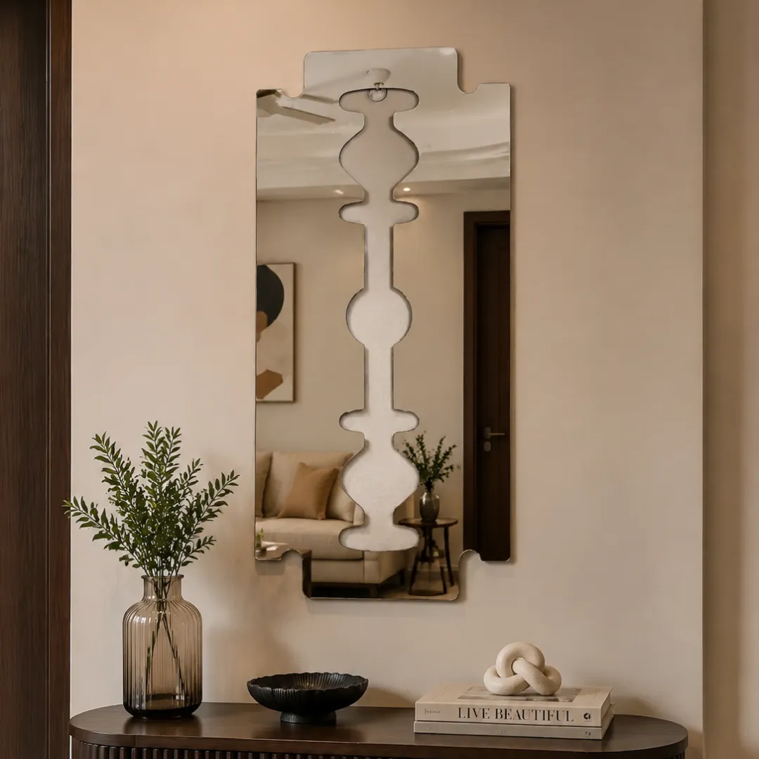 Symmetry decorative wall mirror featuring a unique geometric cutout center design, mounted on a light-colored wall.