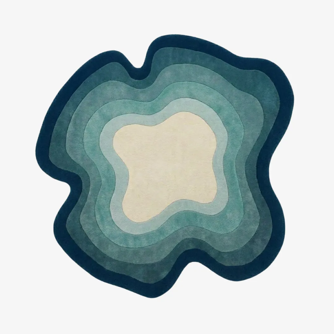 tidal ombre rug top view Tidal Ombre organic irregular-shaped tufted area rug featuring layered ocean blue and cream gradient waves, displayed flat.