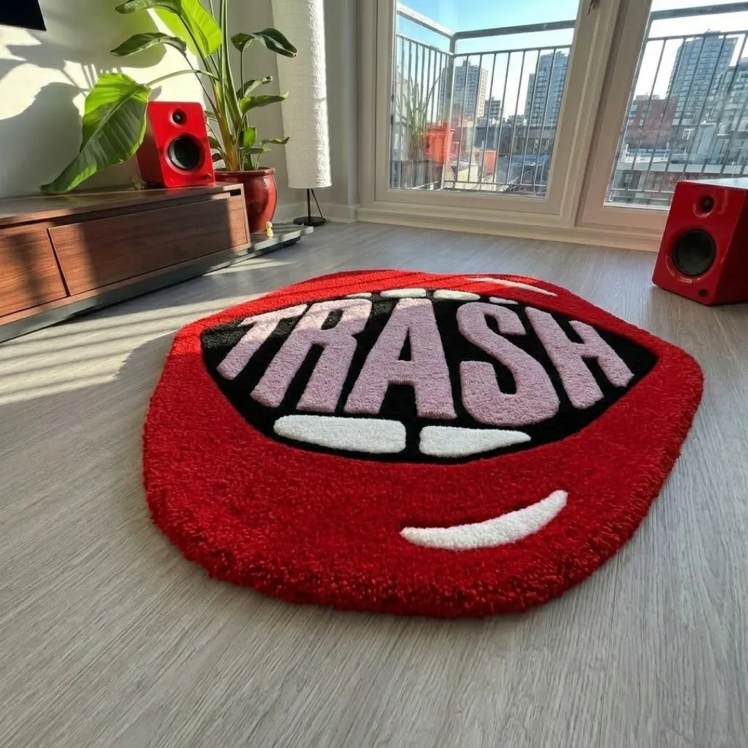 trash lips rug close up texture Close-up macro texture shot of the high-density tufted wool pile, carved letter details, and vibrant colors on the Trash Lips designer rug.