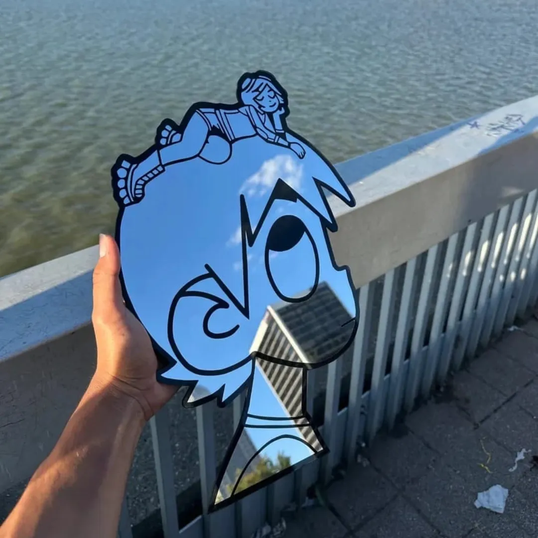 uzi mirror hand held outdoor Uzi character wall mirror held outdoors near a bridge, reflecting the sky, water, and surrounding urban architecture.