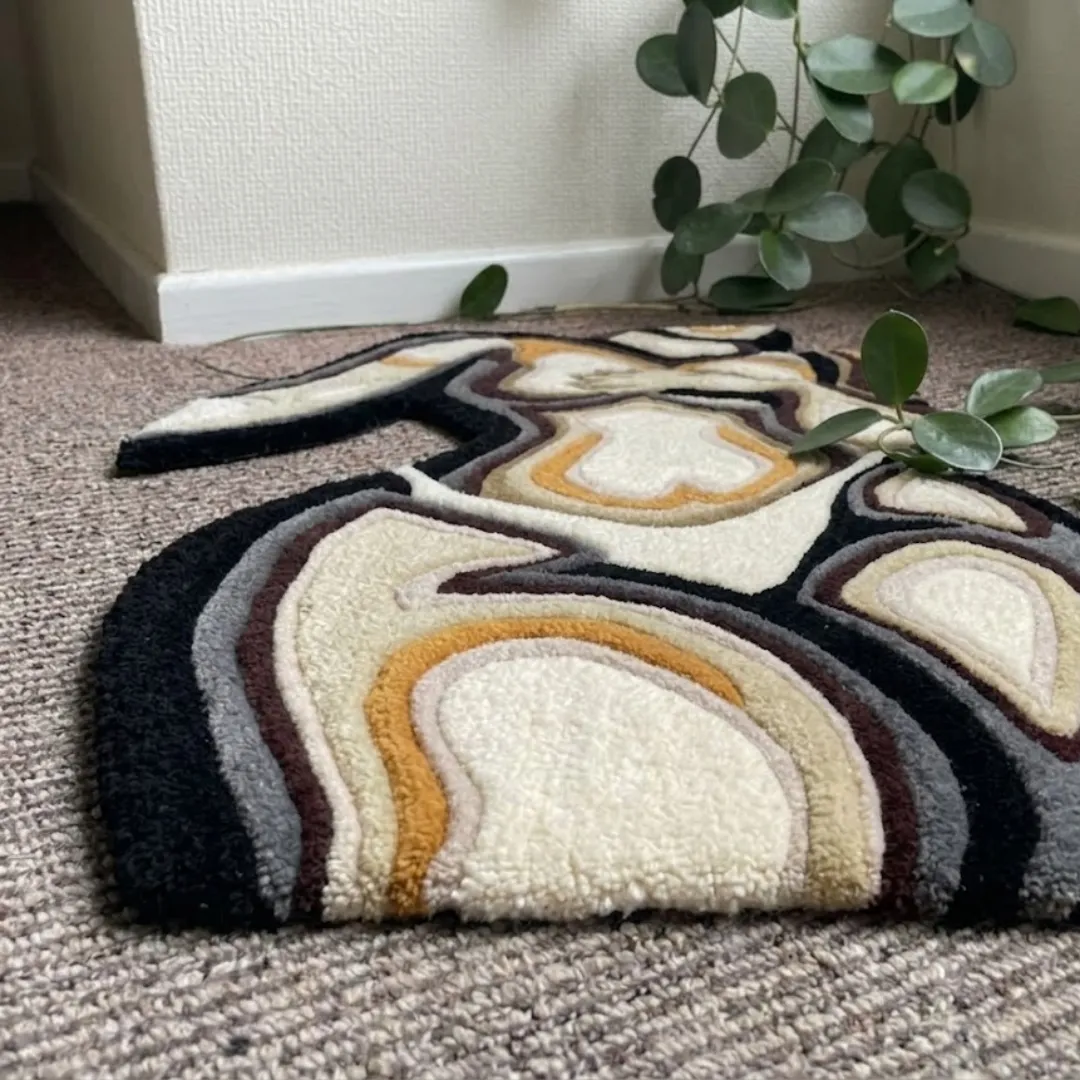 velora rug angle view Angle view of the Velora tufted rug showcasing its unique contour-cut shape, smooth finish, and neutral color block palette.