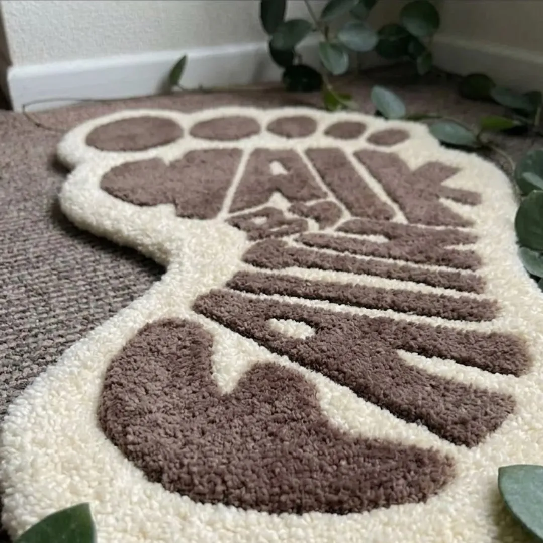 walk by faith rug close up texture Close-up of the plush tufted pile texture, carved contours, and brown yarn lettering on the Walk By Faith designer rug.
