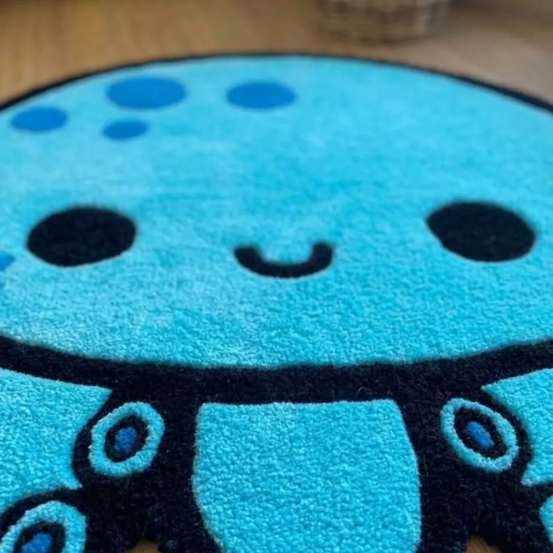 aqua mallow rug close up texture view Close-up macro texture shot of the high-density tufted wool pile, carved contours, and detailed facial features on the Aqua Mallow designer rug.