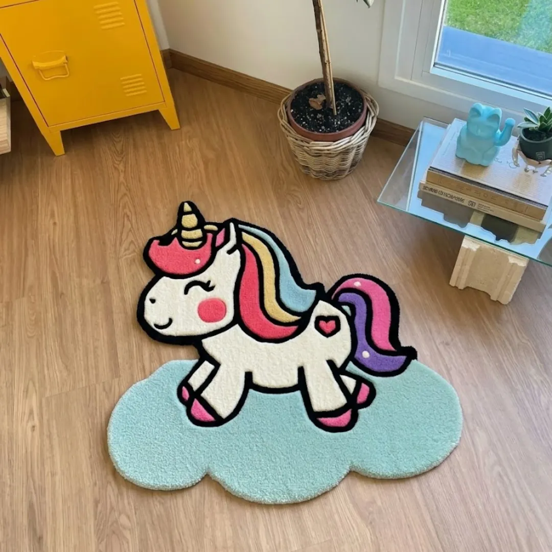 cloudy prance rug overhead room view Cloudy Prance handmade tufted novelty area rug shaped like a cute unicorn galloping on a blue cloud, displayed flat on a wooden floor in a sunny room.