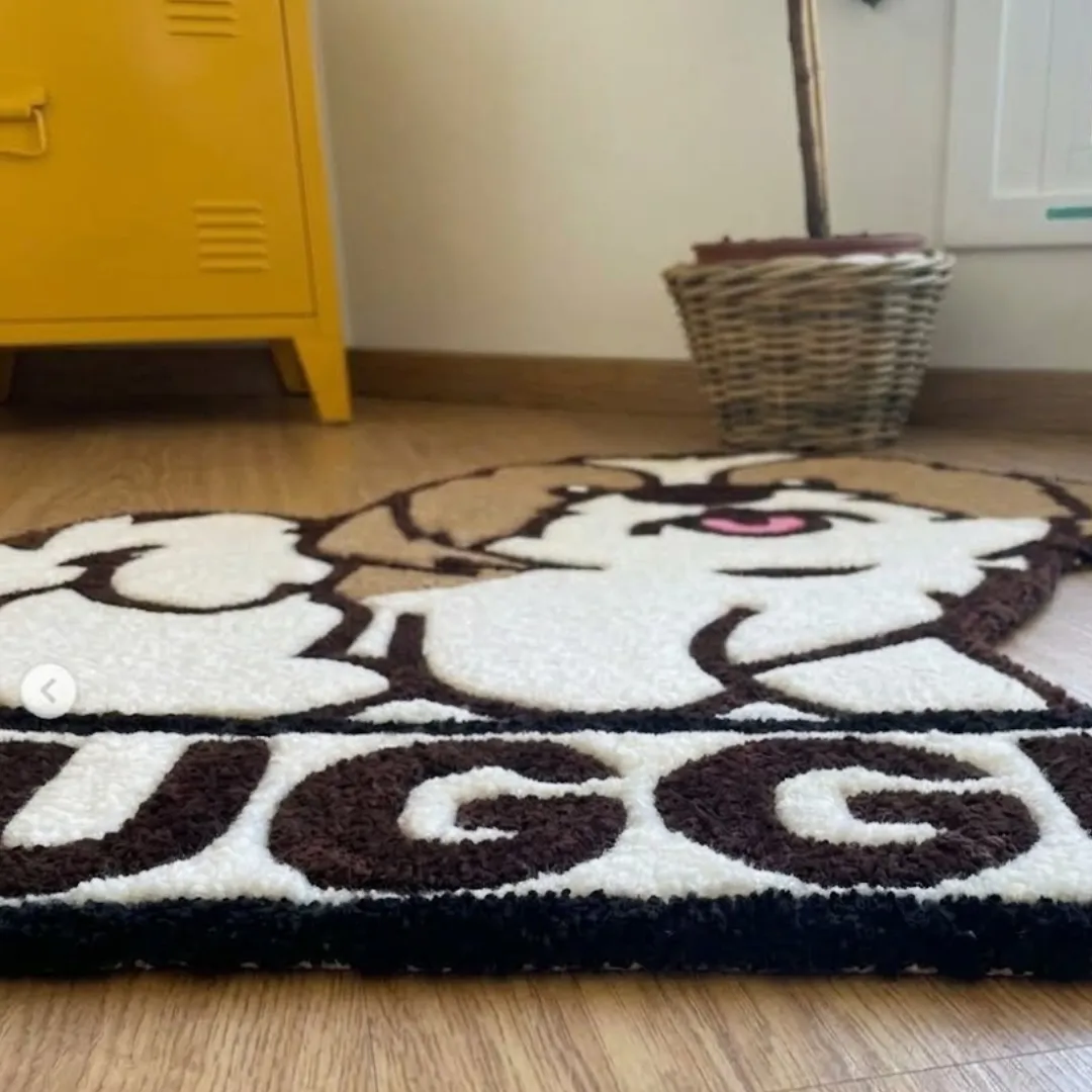 nugget pup rug low angle texture view Low-angle close-up view of the Nugget Pup designer rug highlighting its thick texture, carved contour lines, and custom lettering.