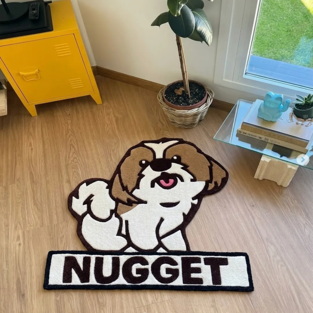 nugget pup rug overhead room view Nugget Pup handmade tufted novelty area rug shaped like a brown and white dog behind a name banner reading "NUGGET", displayed flat on a wooden floor in a sunny room.